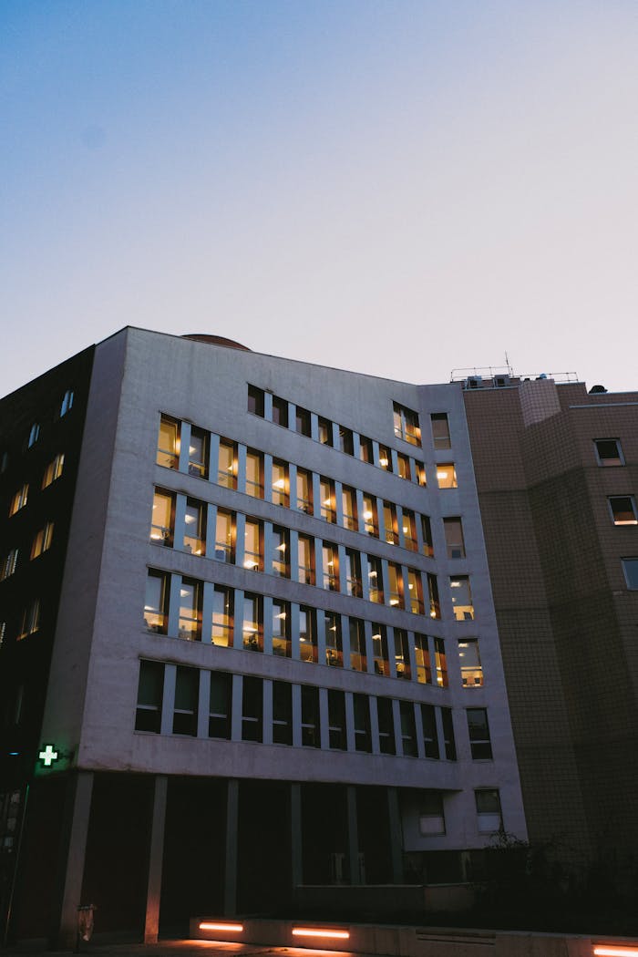 creative Captivating view of a modern office building exterior during twilight with illuminated windows.